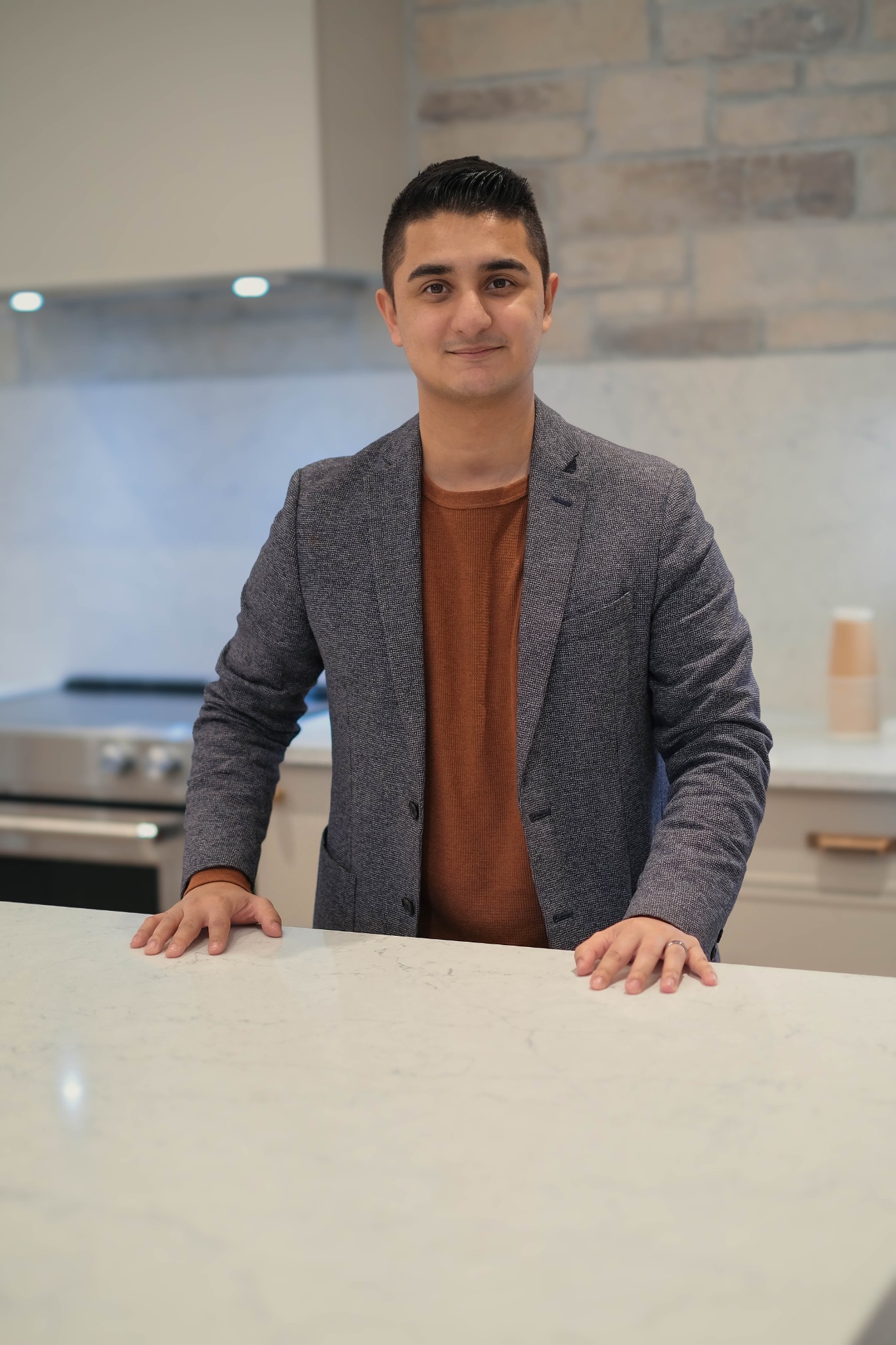 Zain Jafrey standing in a modern home